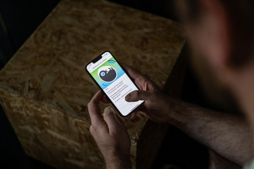 A smartphone with an abstract image of an embryo.