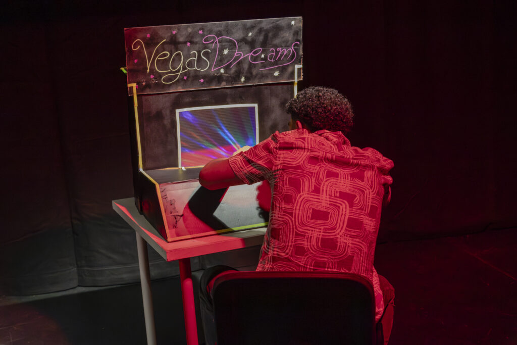 A man is sitting in front of a homemade game console.